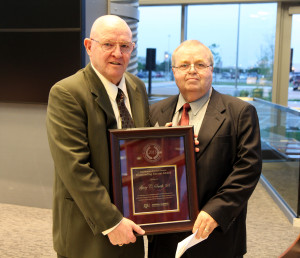 Rod Bowling, Ph.D., right, presents the Animal Science Outstanding Alumni Award to Gary C. Smith '68.
