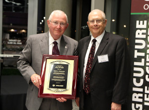 Russell Cross, Ph.D., left, presents Zerle L. Carpenter with a plaque in recognition of Carpenter's induction into the Animal Science Hall of Fame.