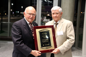Larry Boleman, Ph.D., right, presents a plaque to Paul Engler in recognition of Engler's induction into the Animal Science Hall of Fame.