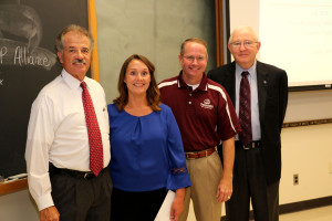 Dr. Bill Dugas, left, acting Vice Chancellor and Dean of Agriculture and Life Sciences, made a surprise visit to Dr. Kerri Gehring's class on Sept. 2 to make the award announcement. He was accompanied by Marty Holmes, Association of Former Students, and Dr. Russell Cross, head of animal science, as well as Gehring's family and graduate students. 