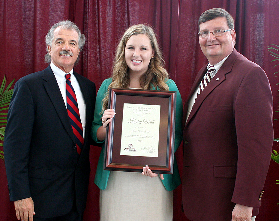 Kayley Wall with Drs. Dugas & Hussey after receiving her senior merit award.