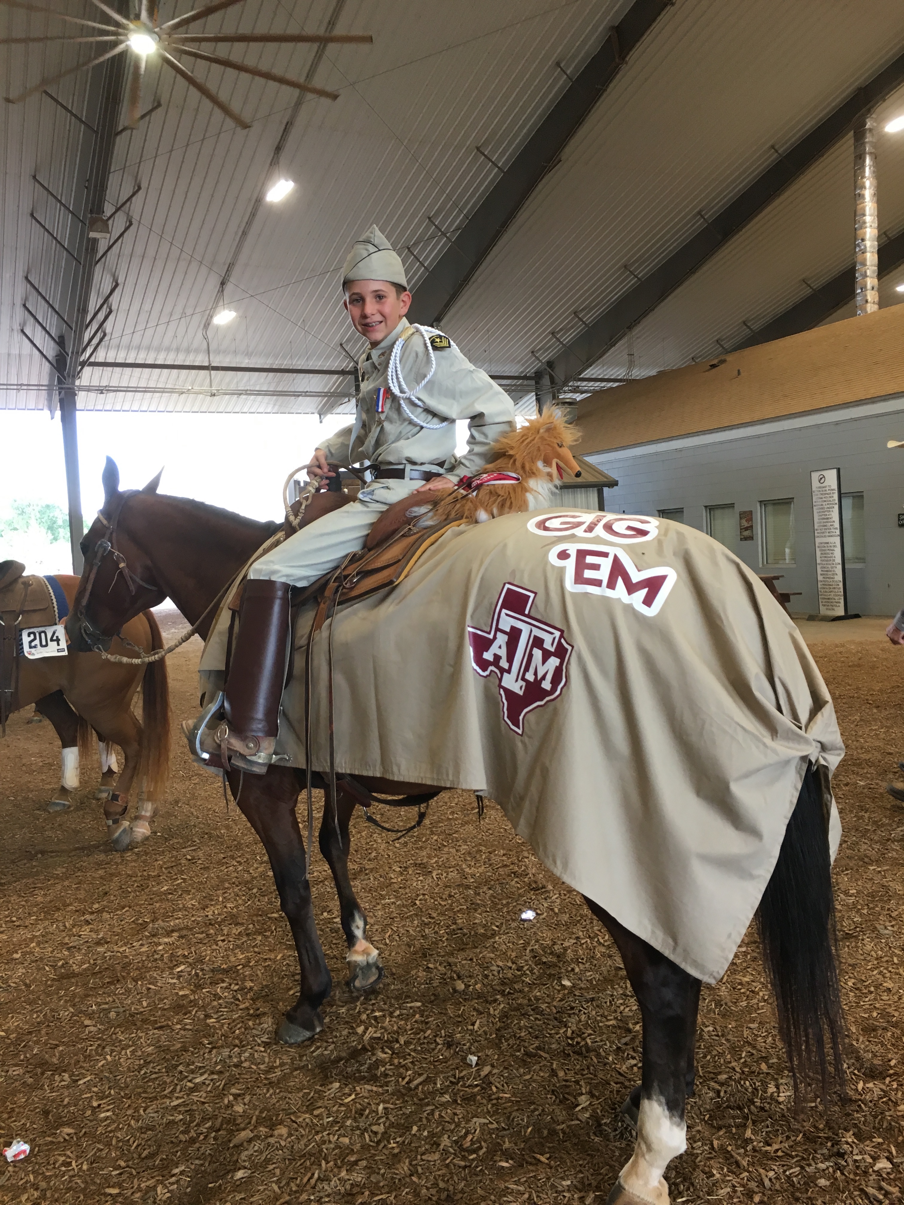 4H youth and horse dressed like a member of the Texas A&M University Corps of Cadets during the freestyle reining event.