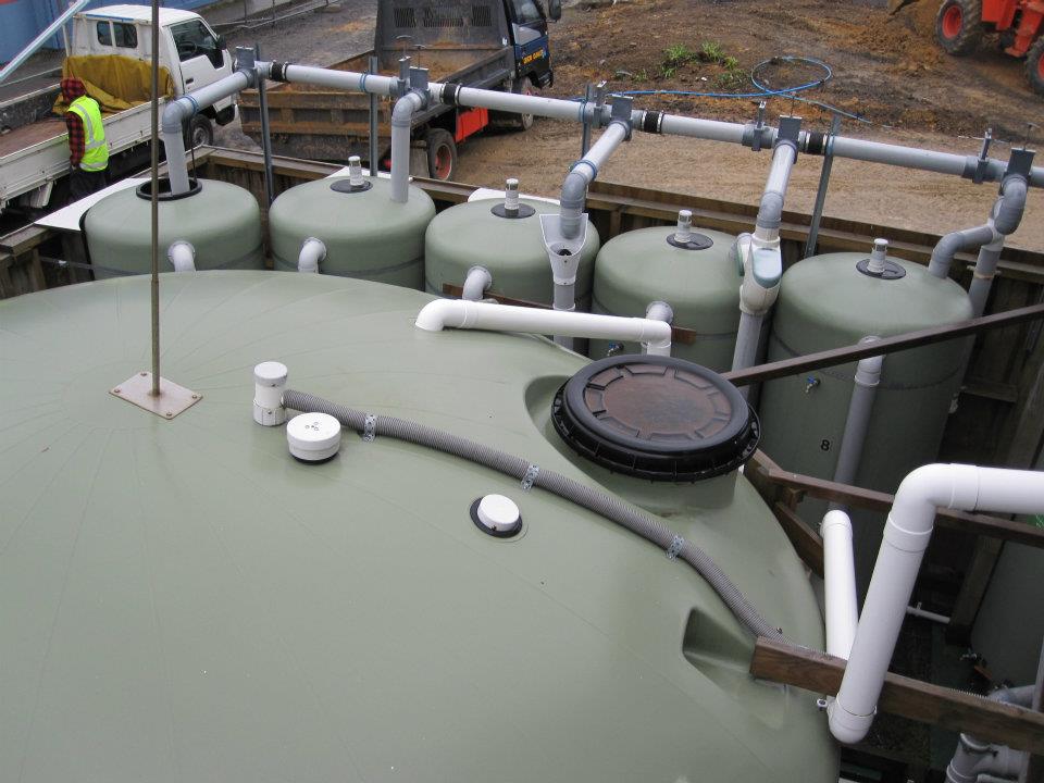 The Roof Water Research Center uses a collection of plastic tanks connected to the University buildings to test various products and system components.