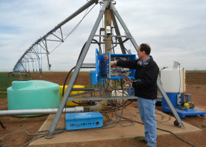 Dr. Charles Hillyer, AgriLife Extension irrigation engineering specialist in Amarillo, runs a test on the variable rate irrigation pivot system at Bushland as part of the Precision Ag Irrigation Leadership project. (Texas A&M AgriLife Communications photo by Kay Ledbetter)