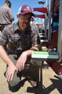 Dr. Seth Murray, Texas A&M AgriLife Research corn breeder, College Station, looks over one of the sensors used as part of a ground phenotyping vehicle used in collecting real-time crop data. (Texas A&M AgriLife Research photo by Blair Fannin)