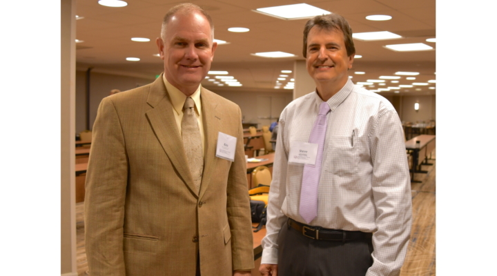 Dr. Thomasson is on the left in a tan blazer standing next to Dr. Steven Thomson wearing a long sleeve button up dress shirt with a pink tie