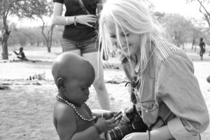 Ashlee Myers and a Himba toddler interacting together. He was quite curious about her iPhone. 
