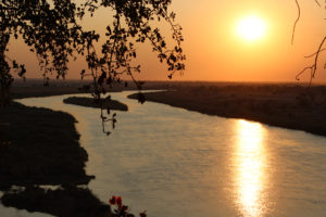 The sun sets slowly over the Kavango River. This is one of the four permanent rivers bordering Namibia.