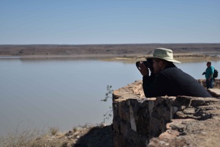 Zeke leaning over the edge, get the shot of the decreased water level in the Hardap Dam because of a three-year drought in Namibia.