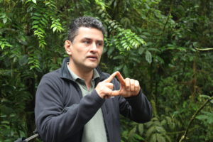 Luis Billa explains a practice used in the conservation of the Nectandra cloud forest reserve.