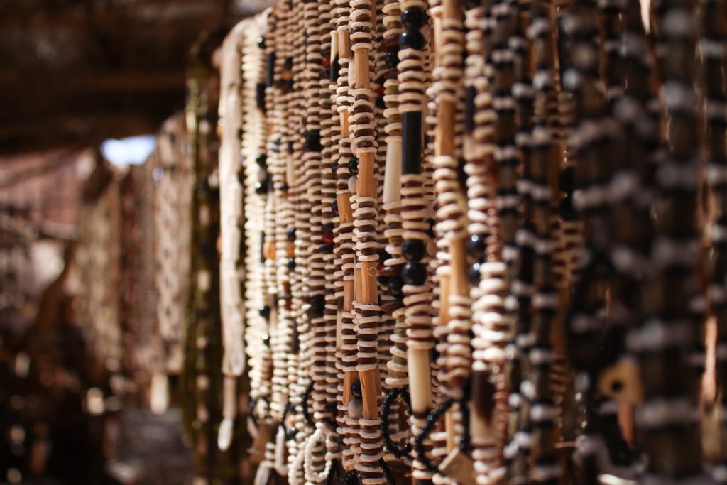 Hundreds of handmade trinkets in the Damara Living Museum available for purchase, including these necklaces made from ostrich egg shell, hollowed porcupine quills and wood. Craft shops provide additional income for many communal landowners, such as the Damara. 