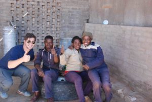 Namibians working on Stampriet Fruit & Vegetable Farm join a member of the Texas A&M Namibia study abroad program for an Aggie Gig ‘em. 