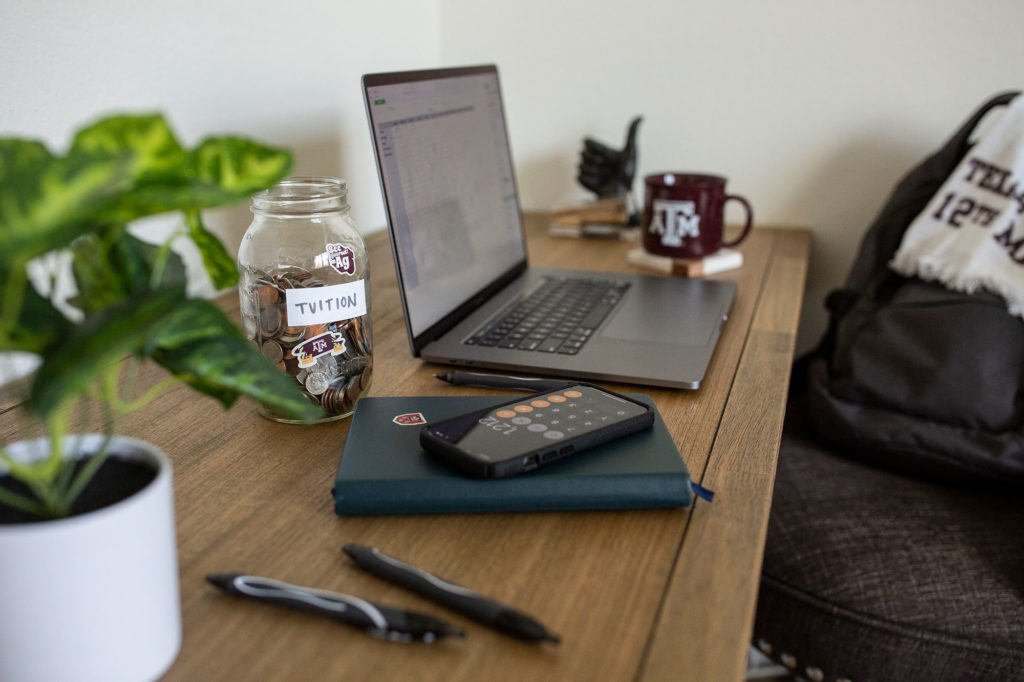 desk with laptop and coin jar