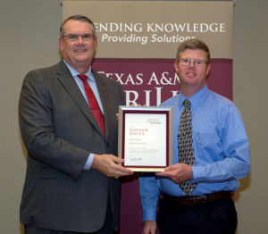 Daniel Hathcoat receives plaque from Extension director.