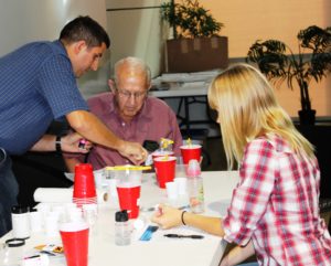 people with cups containing water samples