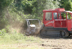 large track-driven mulcher removing undergrowth