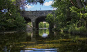 Shoal creek running under a stone bridge