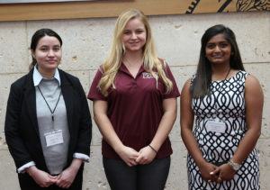three female graduate students standing together