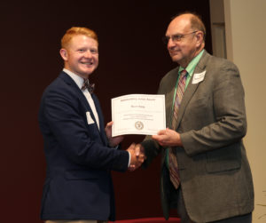 student receiving award from department head