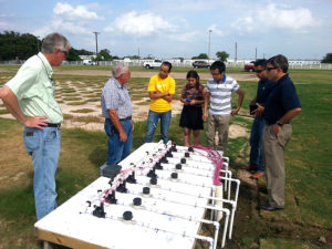 group looking at irrigation manifold