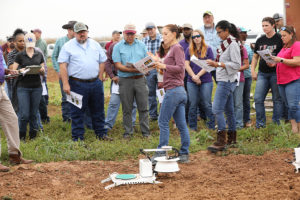 group of people in field by device that captures emmissions from soil